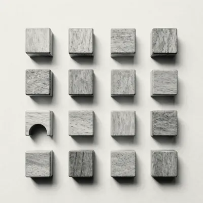 Sixteen wooden blocks laid out in an even grid; one is cut into an arch.